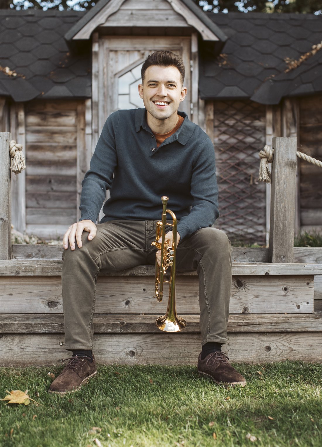 Louis sitting on garden steps with his trumpet